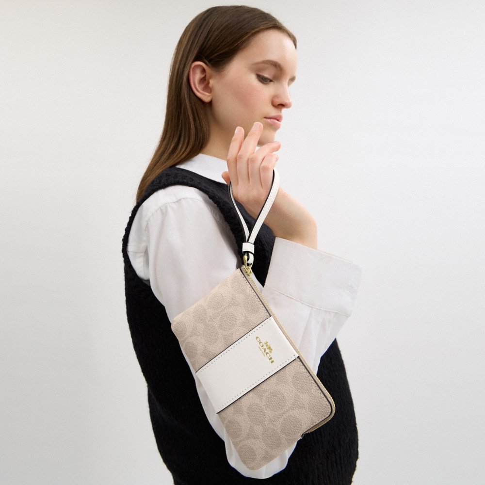 Coach Outlet Corner Zip Wristlet In Signature Canvas With Stripe - Preorder