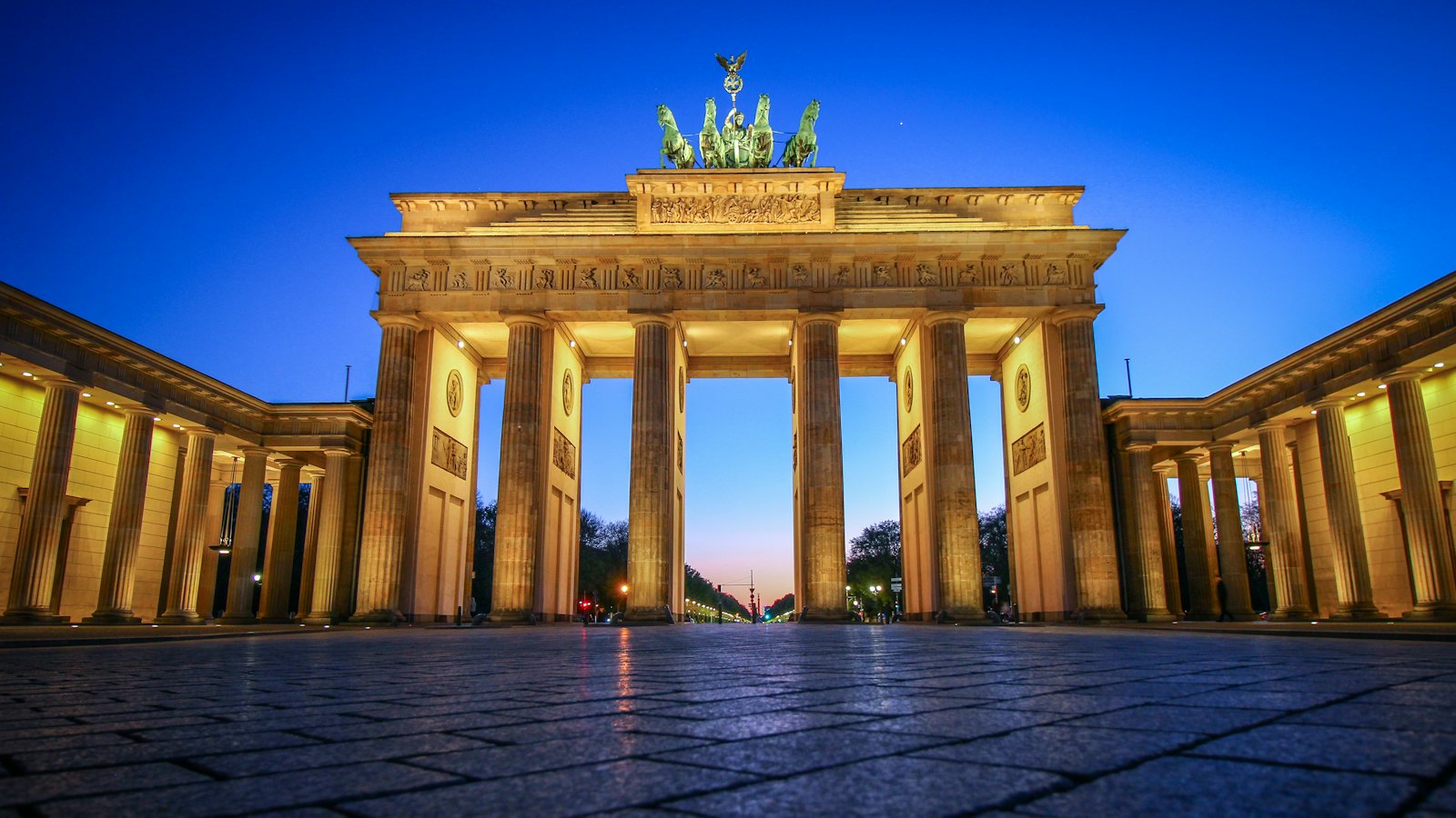 The Brandenburg Gate's columns and quadriga statue illuminated at blue hour in Berlin