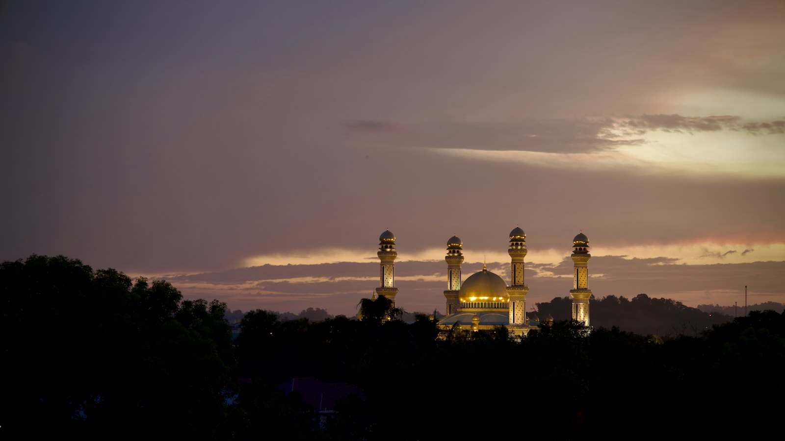 Golden dome and minarets of Jame' Asr Hassanil Bolkiah Mosque lit at dusk, Bandar Seri Begawan