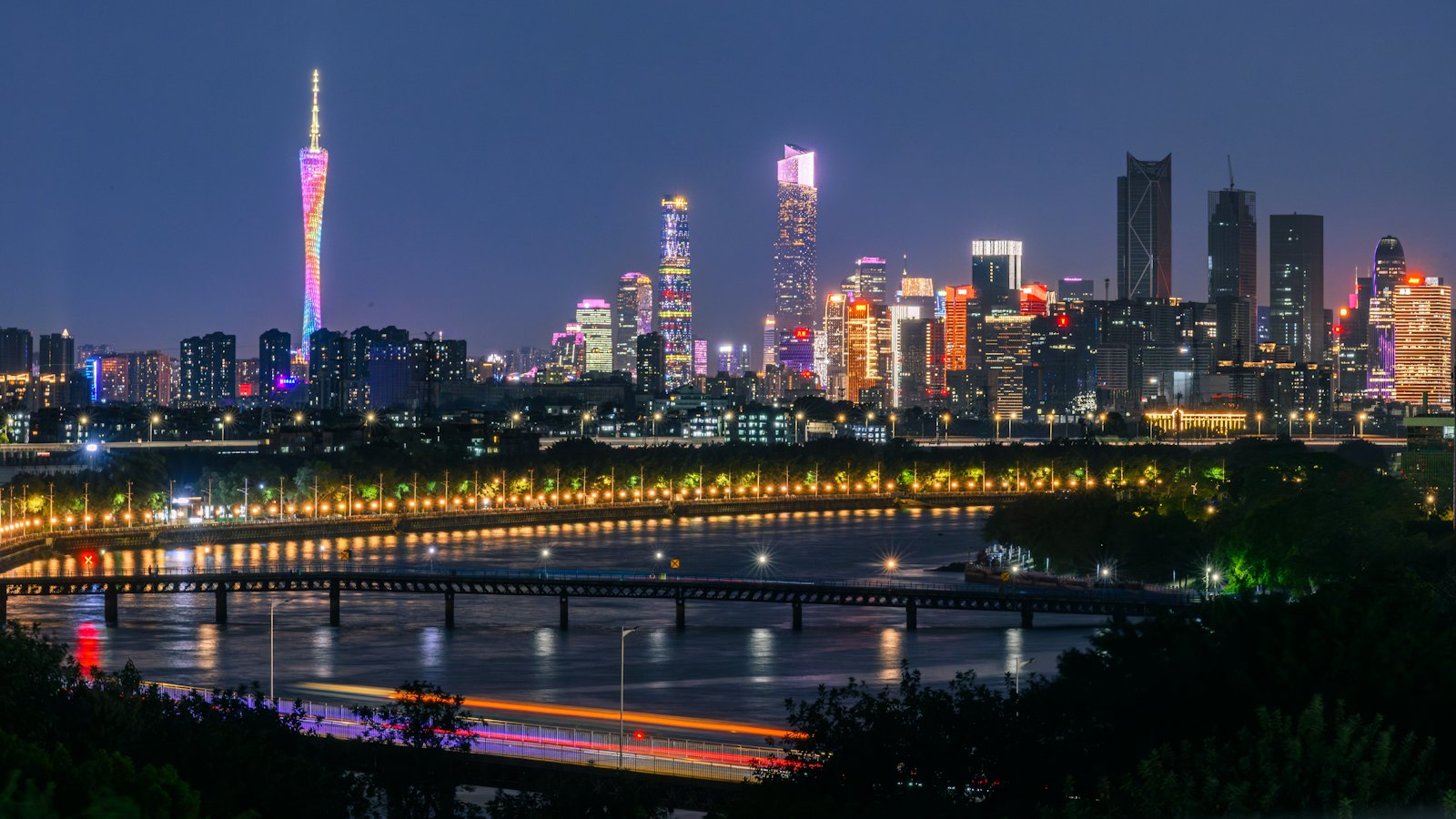 Canton Tower and the Zhujiang New Town skyline glowing over the Pearl River at blue hour, Guangzhou