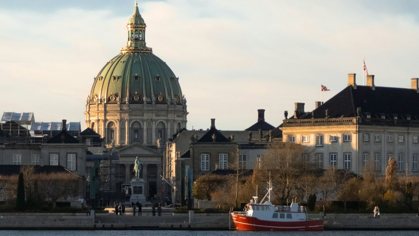 Frederik's Church dome and Amalienborg Palace along Copenhagen's waterfront at golden hour