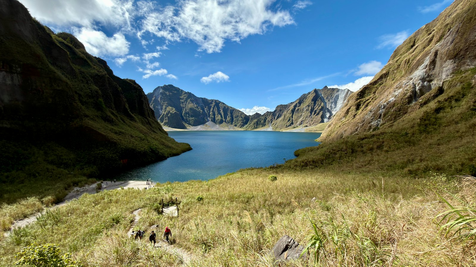 Turquoise crater lake of Mount Pinatubo ringed by volcanic peaks near Clark
