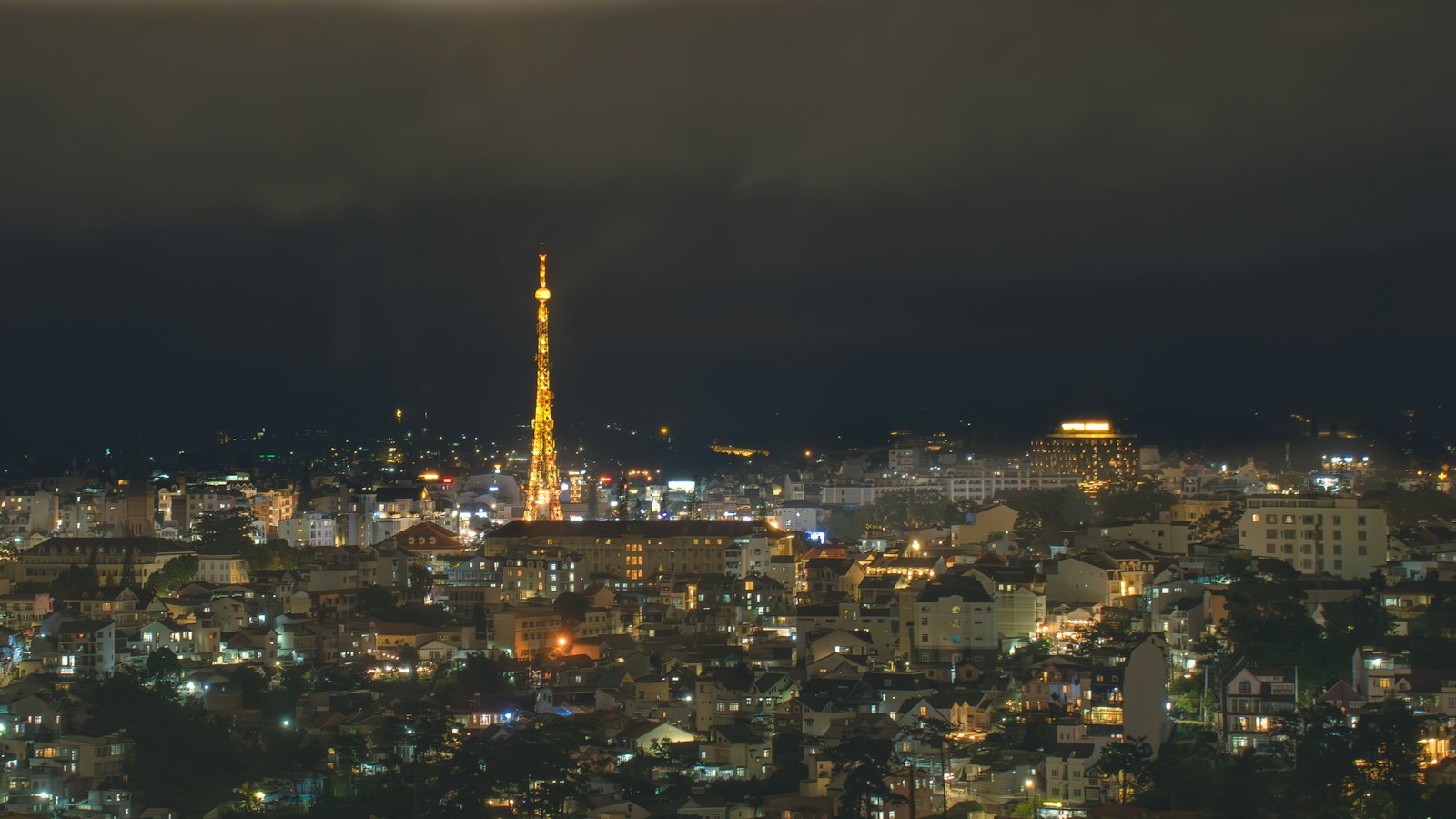 Da Lat's illuminated radio tower glowing above the city at night