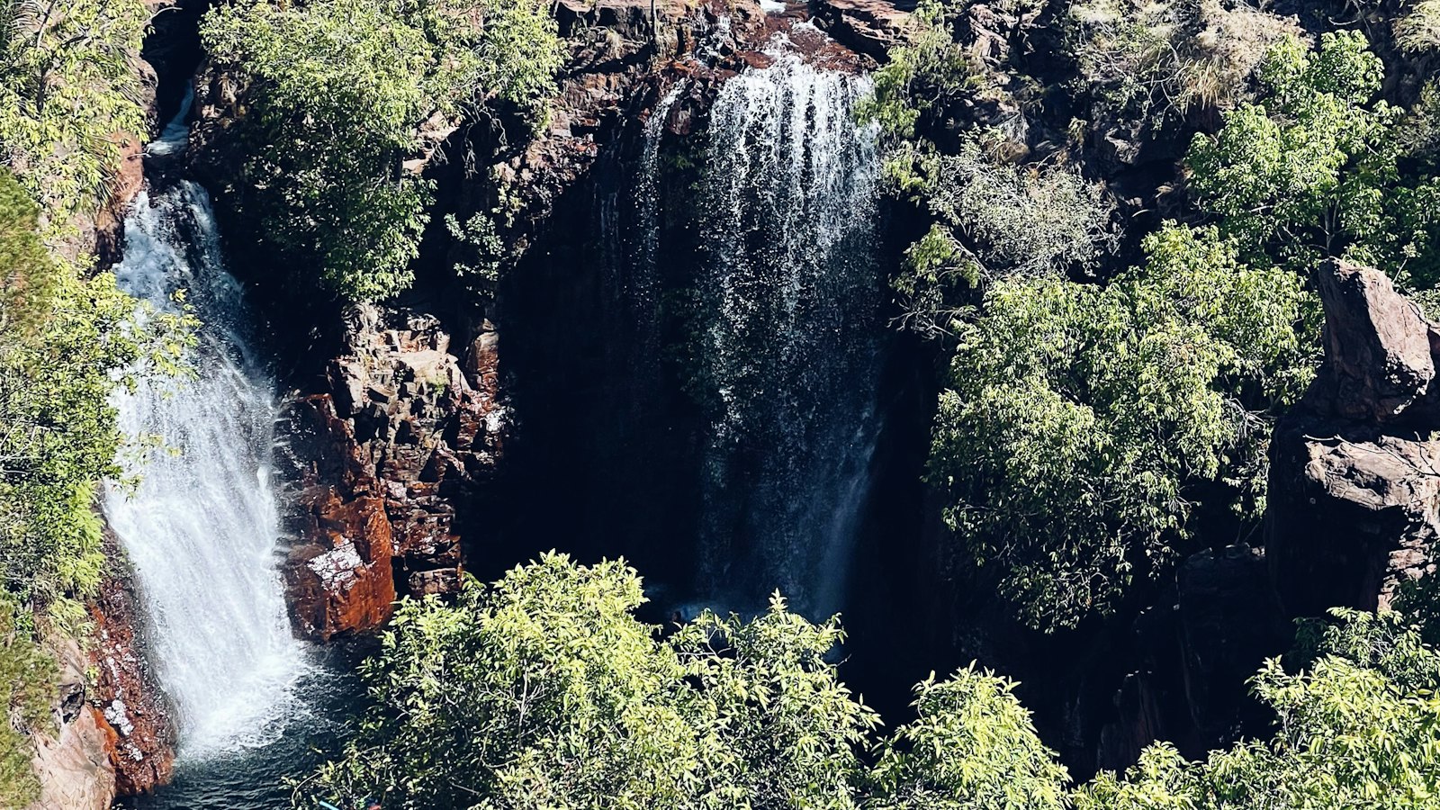 Twin cascades of Florence Falls tumbling into a dark waterhole in Litchfield National Park