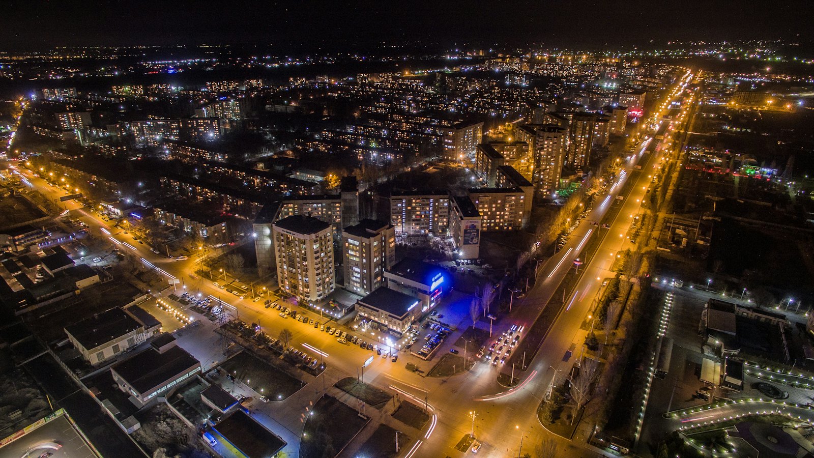 Aerial view of Bishkek's illuminated streets and apartment blocks at night