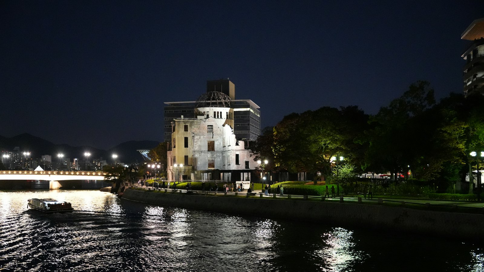 The Atomic Bomb Dome illuminated at night along Hiroshima's Motoyasu River