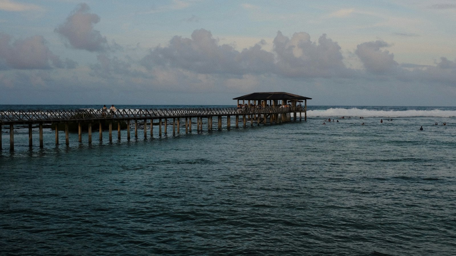 The wooden Cloud 9 boardwalk and surf tower stretching into the sea at Siargao