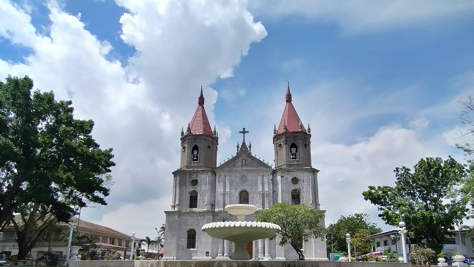 Molo Church with its twin spires and the Molo Plaza fountain in Iloilo City, Philippines