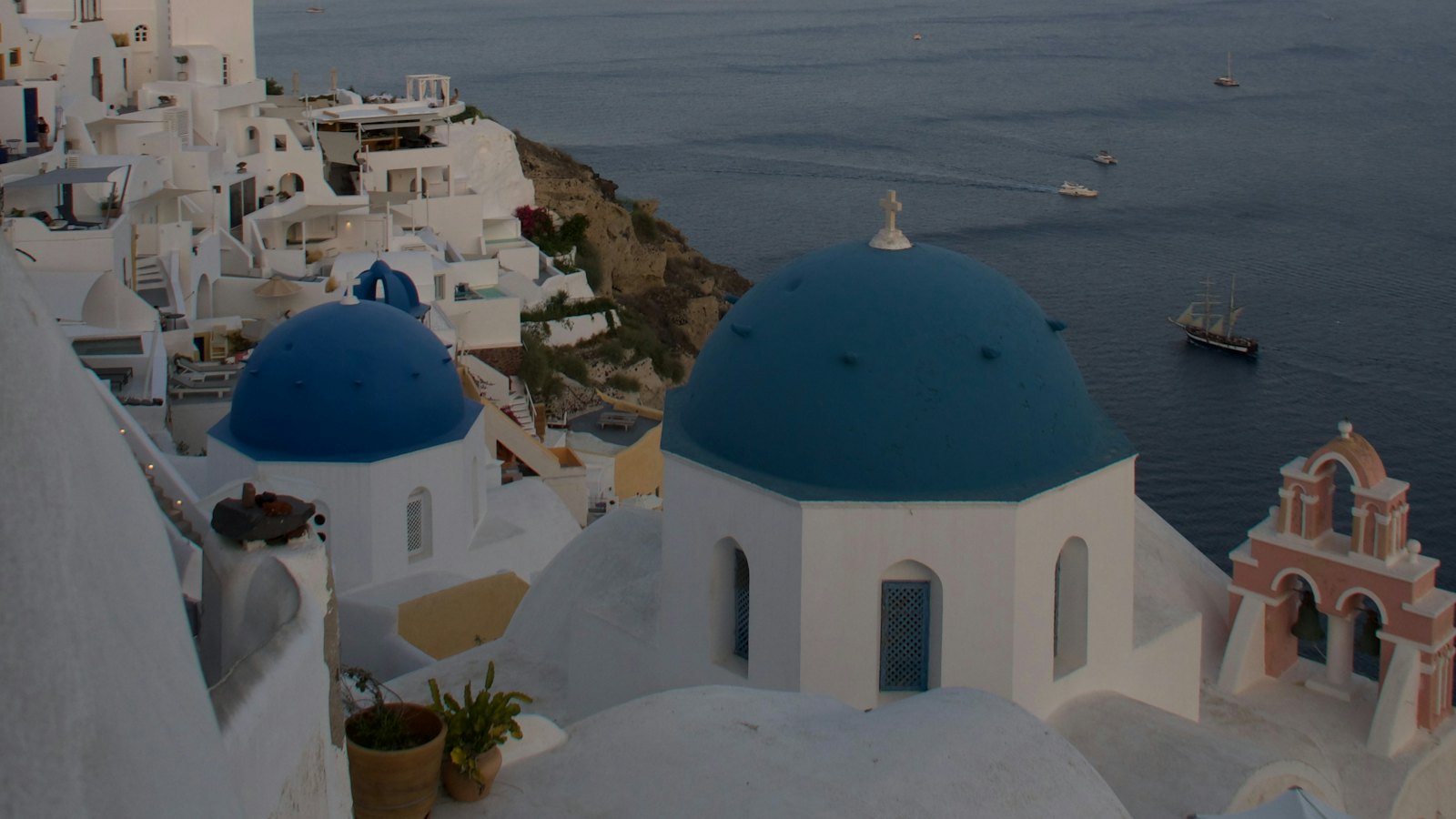 Blue-domed churches overlooking the caldera in Oia, Santorini at dusk