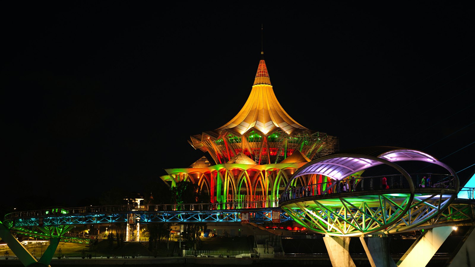 Sarawak State Assembly building and Darul Hana Bridge lit up at night, Kuching