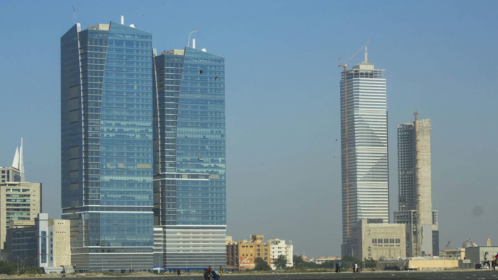 Karachi's Clifton Beach shoreline with the city's glass skyscraper skyline behind it