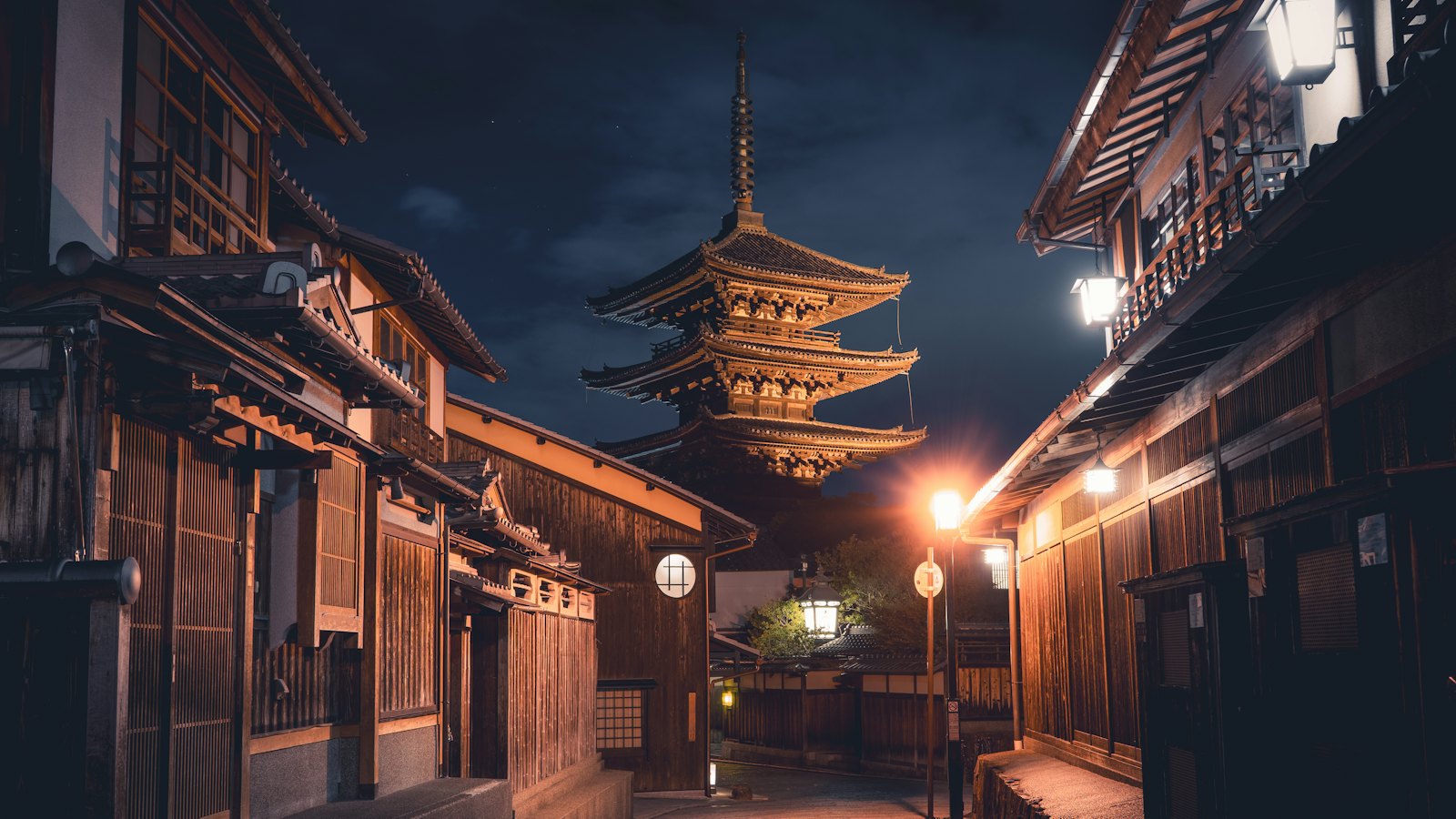 Yasaka Pagoda of Hokan-ji lit at night above an empty lantern-lit Higashiyama street, Kyoto