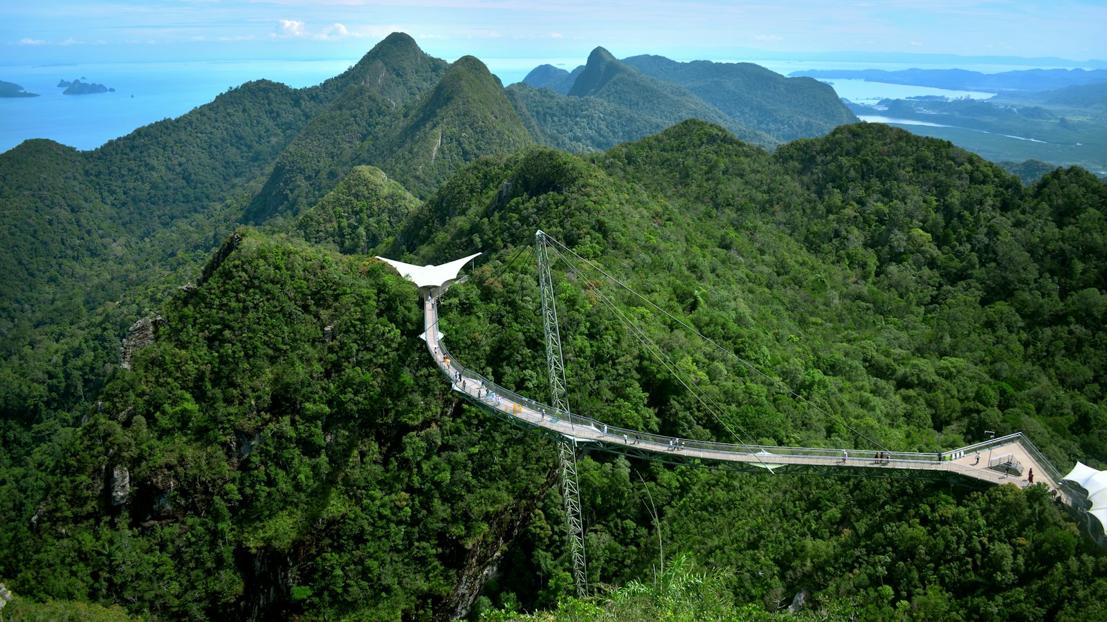 Langkawi Sky Bridge curving over rainforest peaks of Gunung Mat Cincang above the Andaman Sea