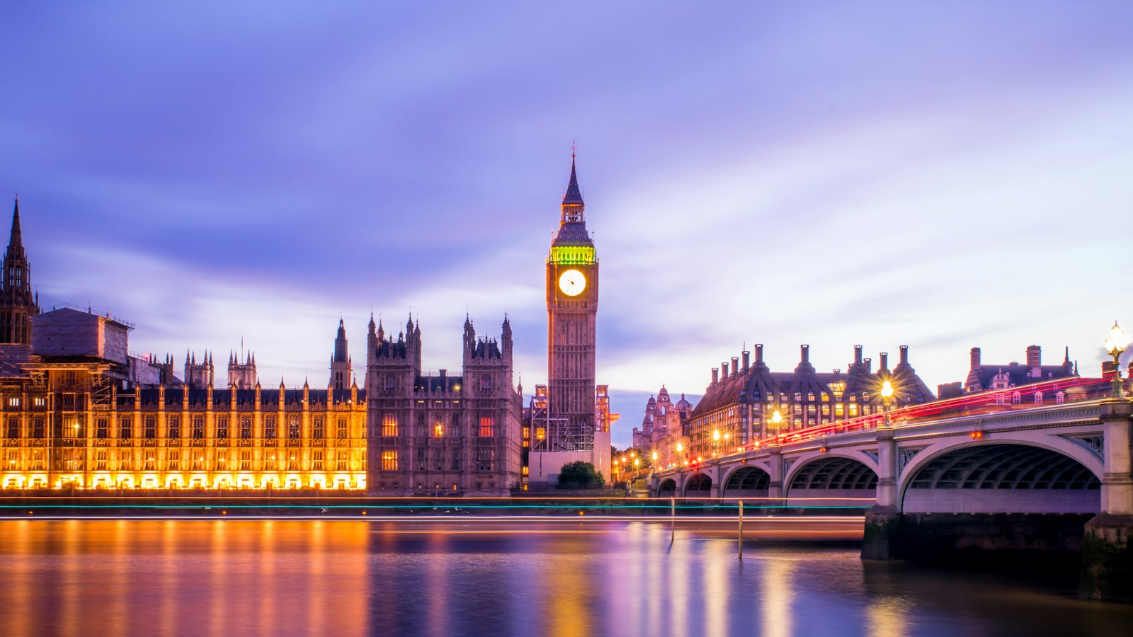 Big Ben and the Houses of Parliament lit at blue hour across the River Thames, London