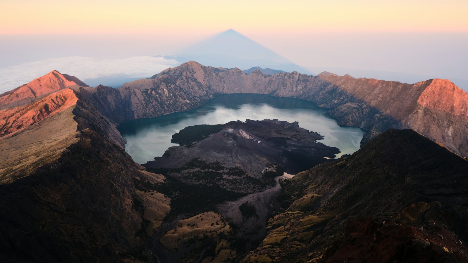 Segara Anak crater lake and Barujari cone inside Mount Rinjani's caldera at sunrise, Lombok