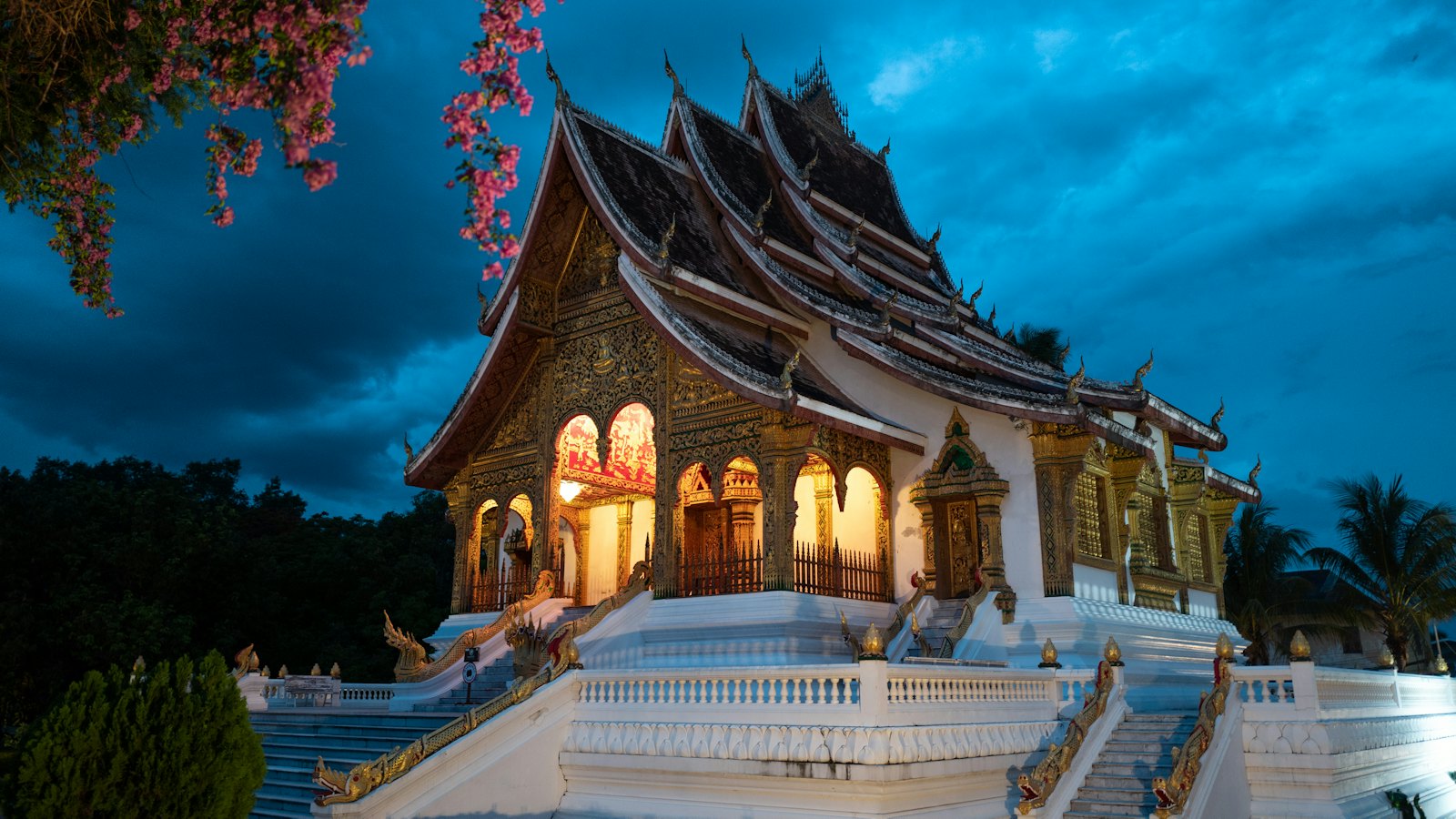 Haw Pha Bang temple at the Royal Palace glowing at blue hour in Luang Prabang, Laos
