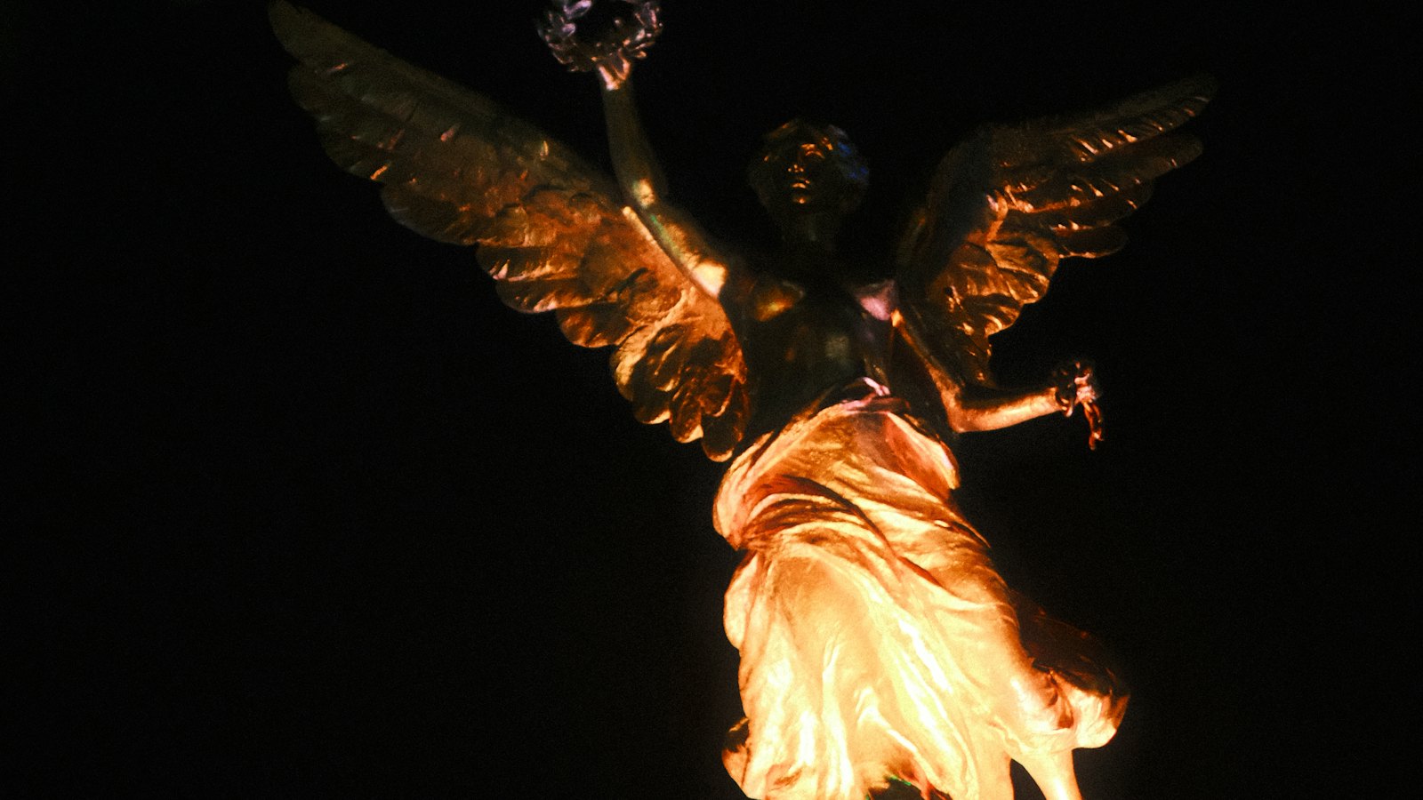 The golden Angel of Independence statue glowing against the night sky in Mexico City
