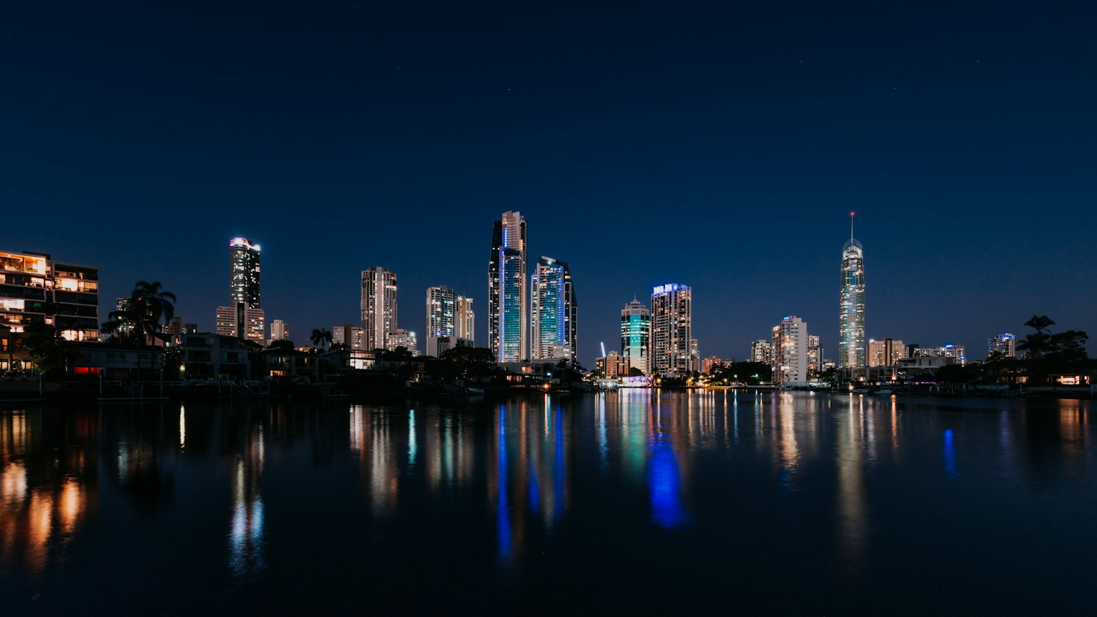 Surfers Paradise skyline and Q1 tower lit at night, reflected in the Nerang River, Gold Coast
