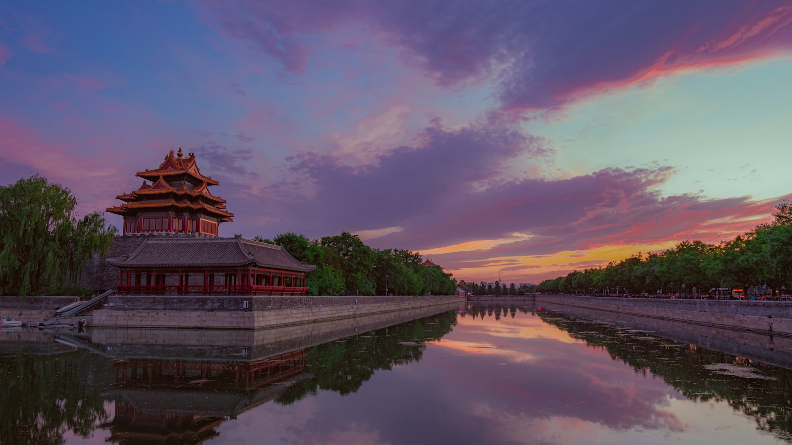 Forbidden City corner tower reflected in the palace moat under a purple dusk sky, Beijing