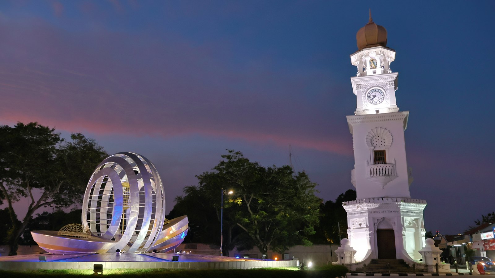 Queen Victoria Memorial Clock Tower lit white against a blue-hour sky in George Town, Penang