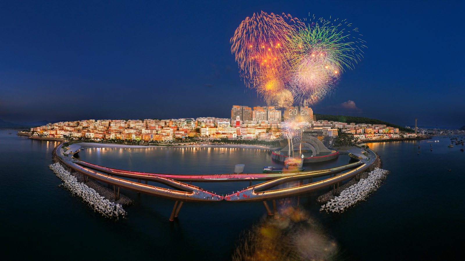 Fireworks over Sunset Town and the lit Kiss Bridge at blue hour, Phu Quoc, Vietnam