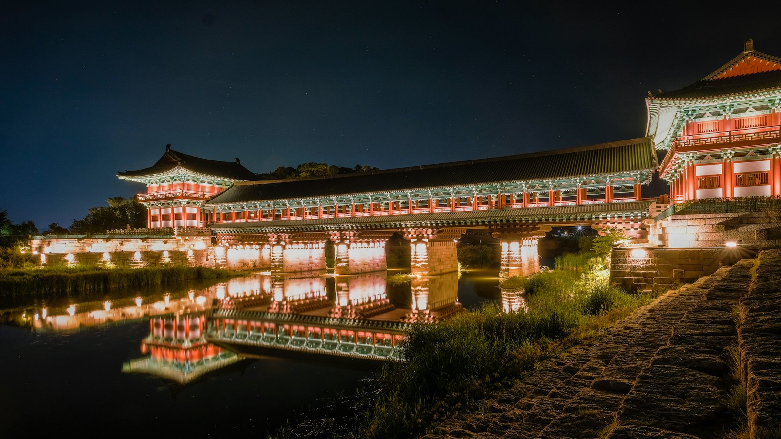 Woljeonggyo Bridge illuminated at night with its reflection in the water in Gyeongju