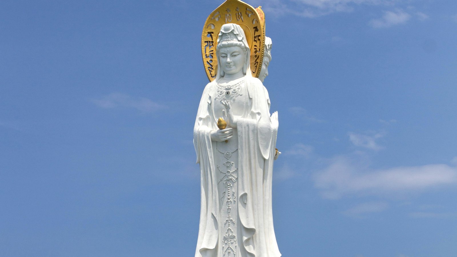 The towering white Guanyin statue rises over the sea at Sanya's Nanshan