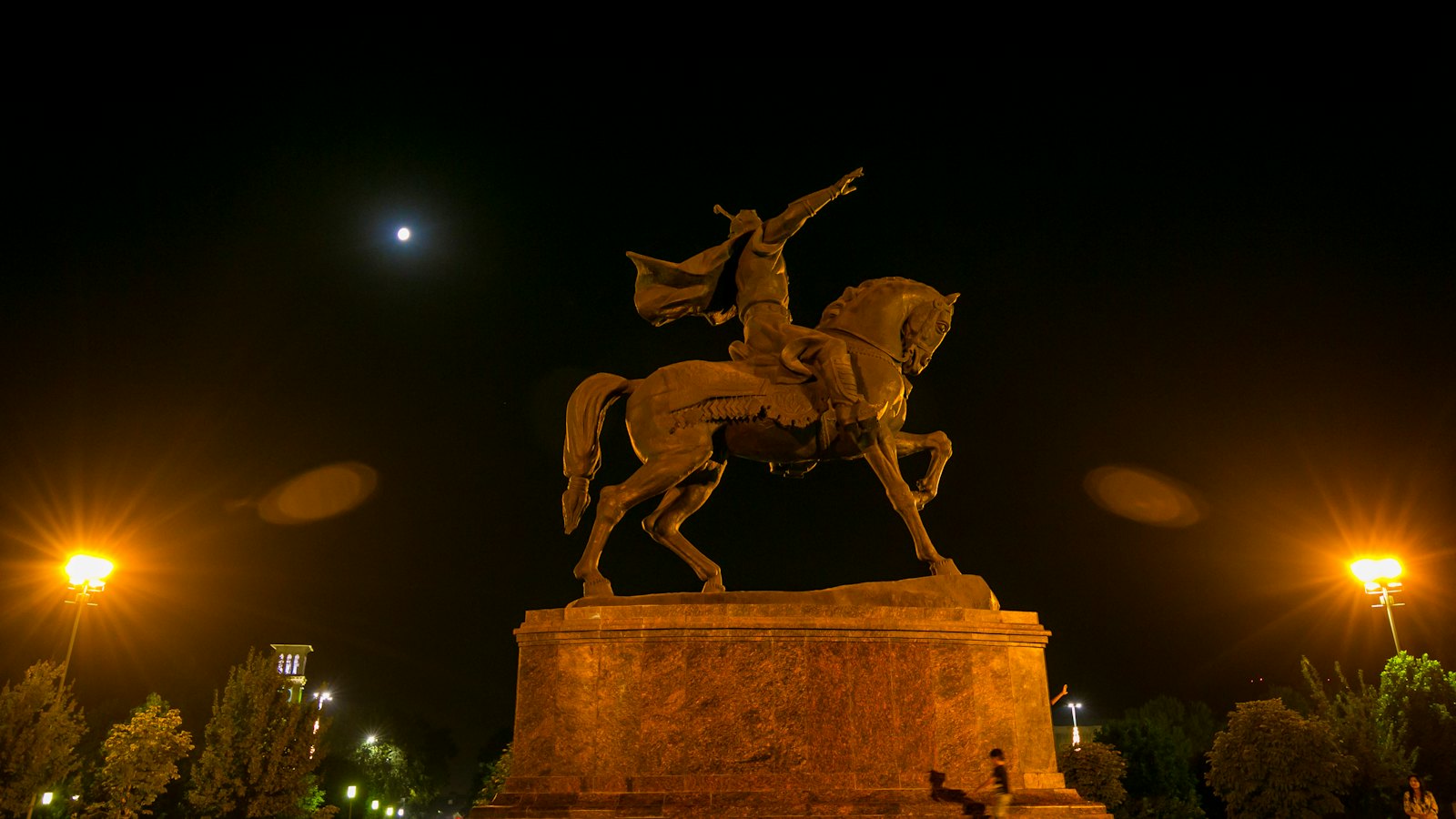 Amir Timur equestrian statue floodlit at night beneath the moon, Amir Temur Square, Tashkent